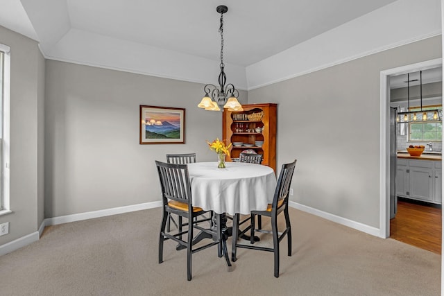 205 Seneca Ct, Franklin, TN 37067 - dining area with a chandelier, light carpet, and a tray ceiling