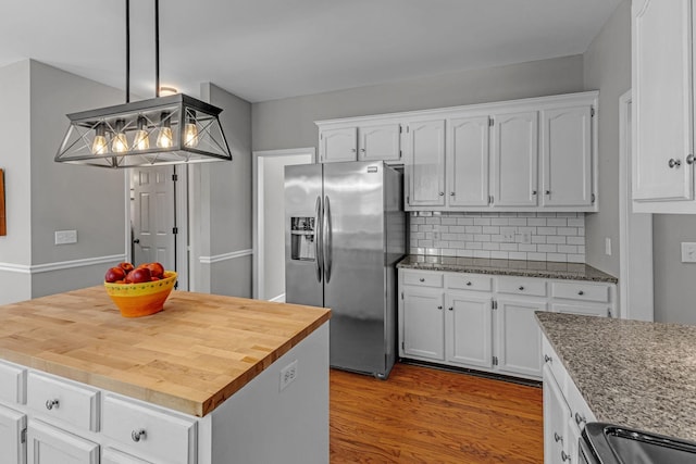 205 Seneca Ct, Franklin, TN 37067 - kitchen with stainless steel refrigerator with ice dispenser, white cabinets, decorative backsplash, wood finished floors, and decorative light fixtures
