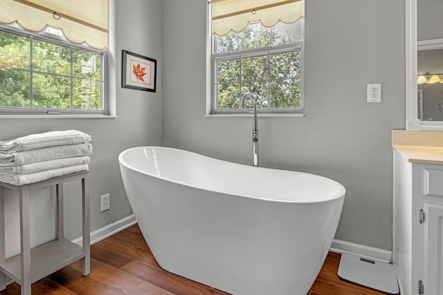 205 Seneca Ct, Franklin, TN 37067 - bathroom with vanity, a soaking tub, and wood finished floors