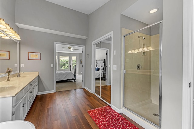 205 Seneca Ct, Franklin, TN 37067 - ensuite bathroom with double vanity, wood-type flooring, a stall shower, and a ceiling fan