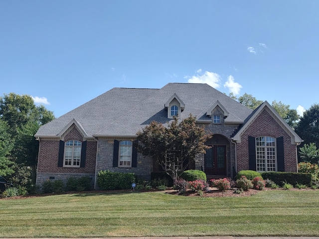 9711 Amethyst Ln, Brentwood, TN 37027 - french country inspired facade with french doors, a front lawn, brick siding, and stone siding