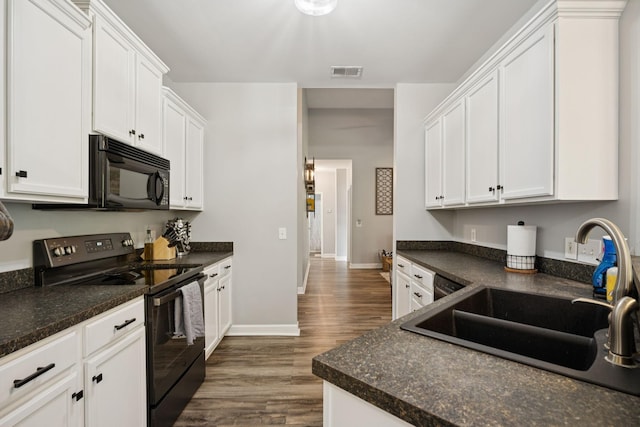 163 Bland Dr, Mount Juliet, TN 37122 - kitchen with black appliances, dark countertops, and dark wood finished floors