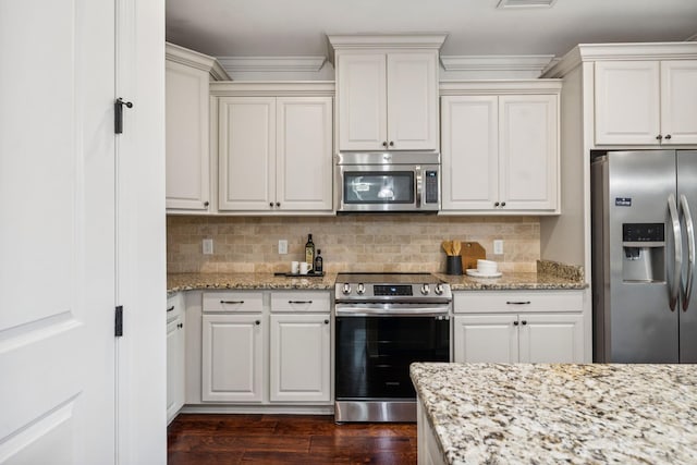 6000 Keats St Unit 202, Franklin, TN 37064 - kitchen with appliances with stainless steel finishes, dark wood-style floors, tasteful backsplash, light stone counters, and white cabinetry