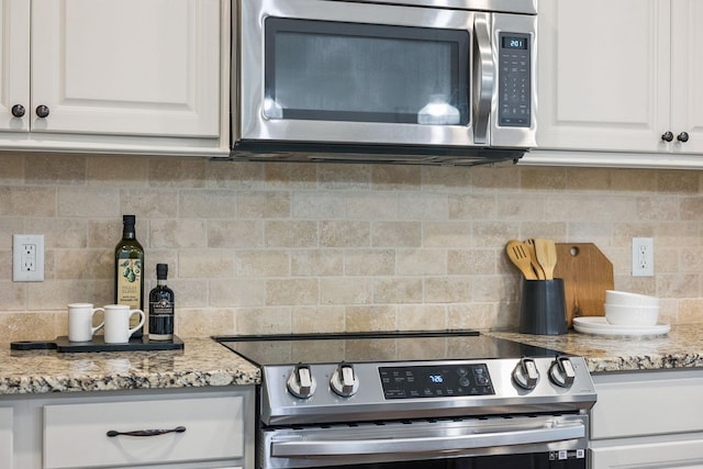 6000 Keats St Unit 202, Franklin, TN 37064 - kitchen with stainless steel appliances, decorative backsplash, white cabinets, and light stone counters