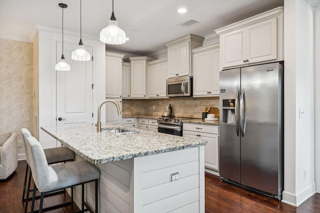 6000 Keats St Unit 202, Franklin, TN 37064 - kitchen with stainless steel appliances, light stone countertops, dark wood-style floors, a kitchen bar, and hanging light fixtures