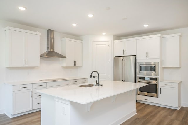 137 W Cassa Way, Mount Juliet, TN 37122 - kitchen with appliances with stainless steel finishes, wall chimney range hood, wood finished floors, decorative backsplash, and recessed lighting