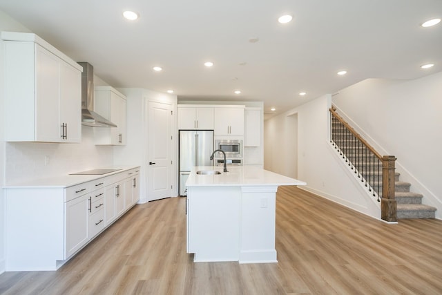 137 W Cassa Way, Mount Juliet, TN 37122 - kitchen featuring wall chimney exhaust hood, stainless steel microwave, high end refrigerator, light wood-type flooring, and light countertops