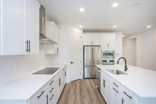 137 W Cassa Way, Mount Juliet, TN 37122 - kitchen featuring wall chimney exhaust hood, stainless steel appliances, white cabinets, light wood-style floors, and backsplash
