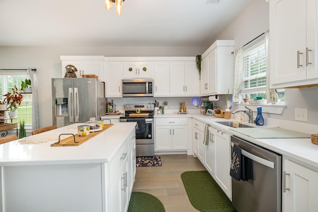 252 Caroline Dr Unit A, Murfreesboro, TN 37128 - kitchen with appliances with stainless steel finishes, light wood-style floors, light countertops, and white cabinets