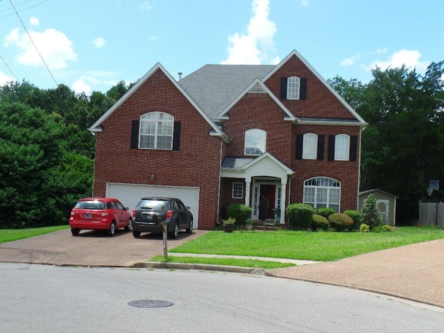 3736 Lipton Pl, Antioch, TN 37013 - view of front of house featuring a garage, concrete driveway, a front lawn, and brick siding