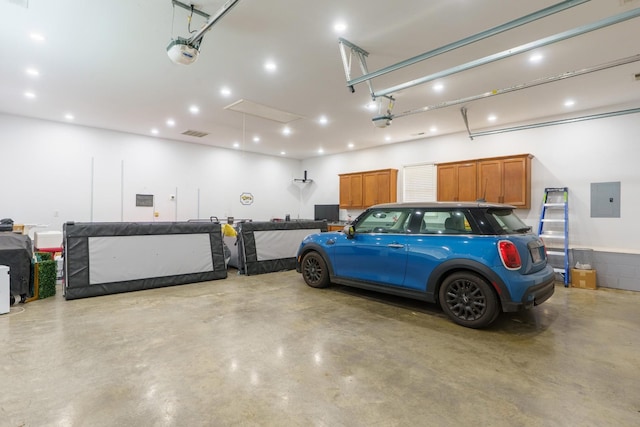 3351 Oak Burr Dr, Chattanooga, TN 37419 - garage featuring electric panel, a garage door opener, and recessed lighting