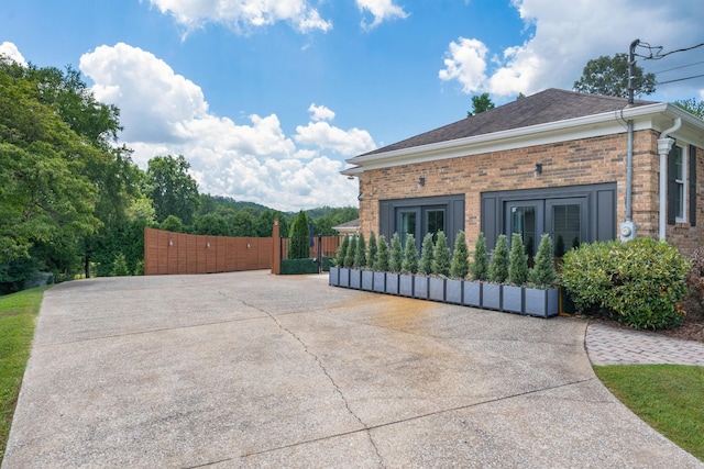 3351 Oak Burr Dr, Chattanooga, TN 37419 - view of home's exterior featuring french doors, brick siding, a gate, and a shingled roof