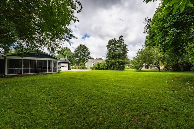 818 W Clark Blvd, Murfreesboro, TN 37129 - view of green lawn featuring a sunroom, concrete driveway, and an attached garage
