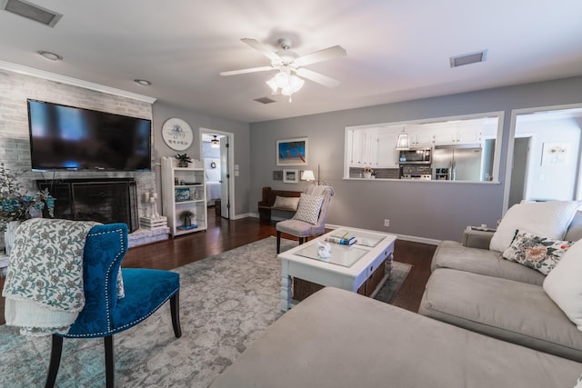 818 W Clark Blvd, Murfreesboro, TN 37129 - living area with dark wood-style floors, a ceiling fan, and a large fireplace