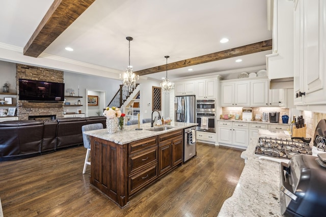 1300 Stovall Ln, Mount Juliet, TN 37122 - kitchen with a chandelier, beamed ceiling, a fireplace, white cabinets, and ornamental molding