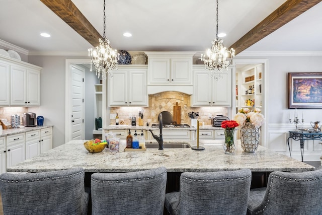 1300 Stovall Ln, Mount Juliet, TN 37122 - kitchen with a chandelier, a kitchen breakfast bar, tasteful backsplash, white cabinetry, and recessed lighting