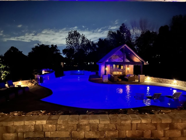 1300 Stovall Ln, Mount Juliet, TN 37122 - pool at twilight featuring an outdoor living space, an outdoor pool, a patio, an exterior structure, and an outbuilding
