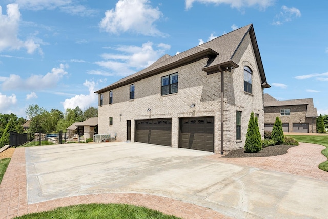1300 Stovall Ln, Mount Juliet, TN 37122 - view of home's exterior with concrete driveway, a garage, brick siding, and roof with shingles