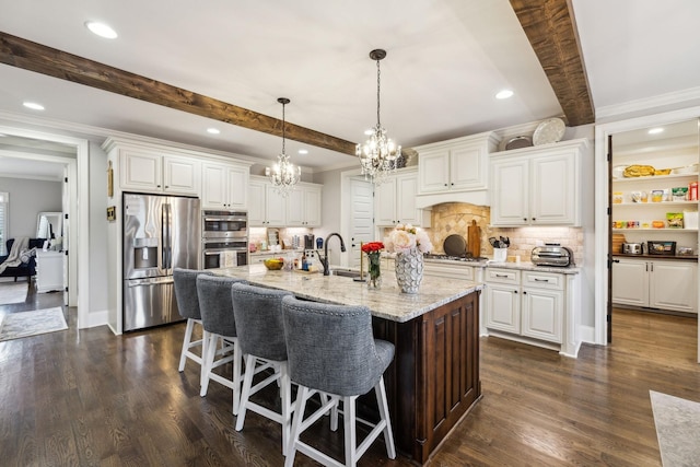 1300 Stovall Ln, Mount Juliet, TN 37122 - kitchen featuring appliances with stainless steel finishes, a chandelier, crown molding, tasteful backsplash, and white cabinets
