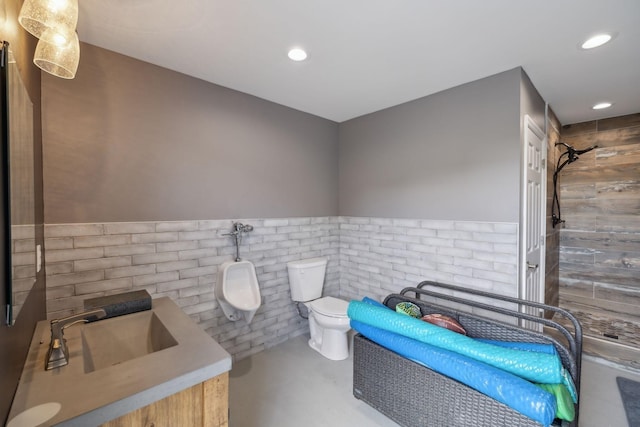 1300 Stovall Ln, Mount Juliet, TN 37122 - bathroom featuring tiled shower, a wainscoted wall, vanity, finished concrete floors, and recessed lighting