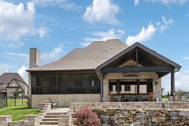 1300 Stovall Ln, Mount Juliet, TN 37122 - rear view of house with a sunroom, a chimney, a patio, and brick siding
