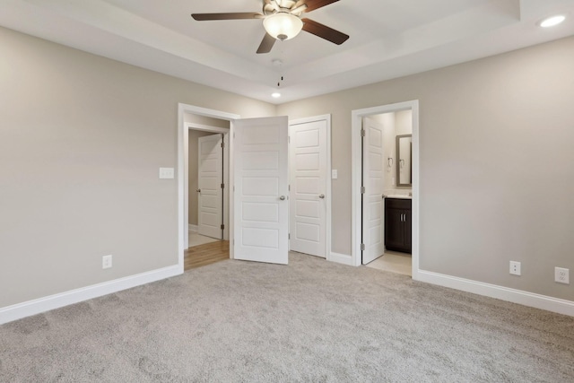 146 Irish Hls, Clarksville, TN 37042 - unfurnished bedroom with light carpet, a tray ceiling, recessed lighting, connected bathroom, and a ceiling fan