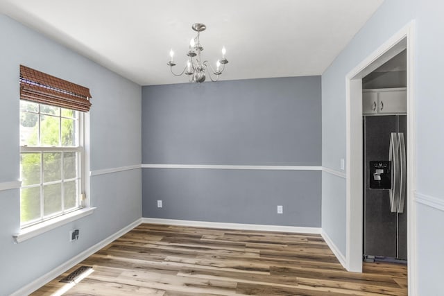 732 Charlie Gann Rd, Old Hickory, TN 37138 - unfurnished dining area featuring a chandelier and wood finished floors