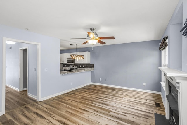 732 Charlie Gann Rd, Old Hickory, TN 37138 - unfurnished living room featuring ceiling fan, wood finished floors, and a fireplace