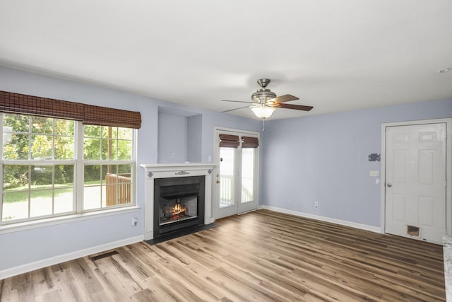 732 Charlie Gann Rd, Old Hickory, TN 37138 - unfurnished living room with ceiling fan, wood finished floors, plenty of natural light, and a fireplace with flush hearth