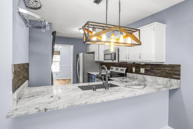 732 Charlie Gann Rd, Old Hickory, TN 37138 - kitchen with stainless steel appliances, decorative backsplash, white cabinets, and wood finished floors