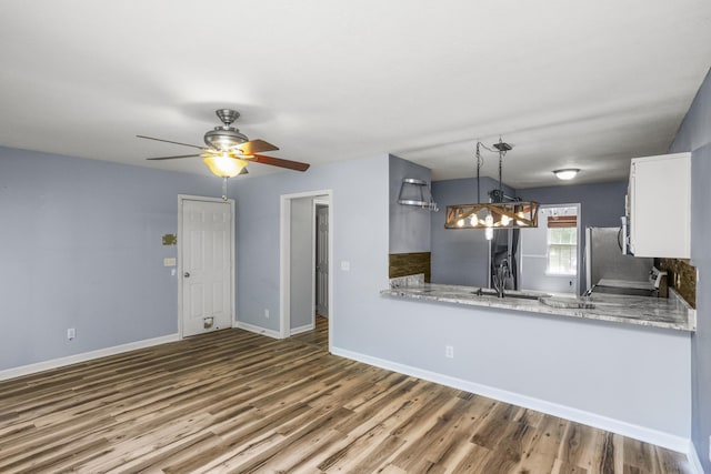 732 Charlie Gann Rd, Old Hickory, TN 37138 - kitchen featuring white cabinets, wood finished floors, ceiling fan, decorative light fixtures, and freestanding refrigerator