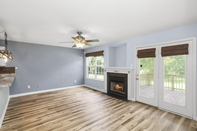 732 Charlie Gann Rd, Old Hickory, TN 37138 - unfurnished living room featuring wood finished floors, a ceiling fan, and a fireplace with flush hearth