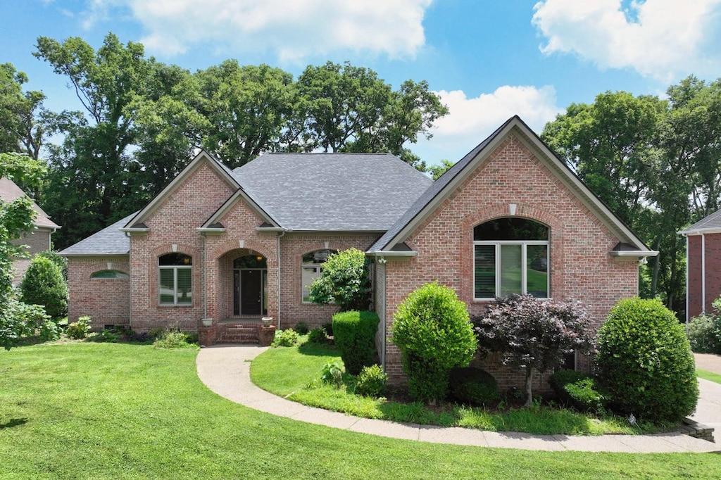1440 Station Four Ln, Old Hickory, TN 37138 - view of front of home featuring brick siding, a front lawn, and a shingled roof