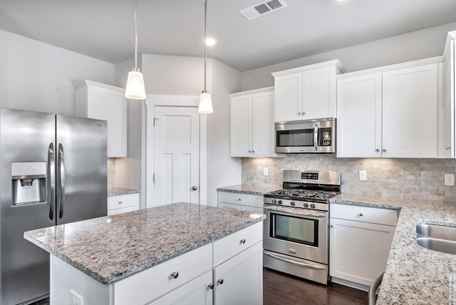 4905 Kingdom Dr, Murfreesboro, TN 37128 - kitchen featuring appliances with stainless steel finishes, white cabinetry, a kitchen island, and tasteful backsplash