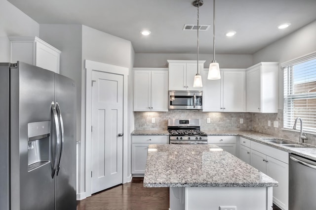 4905 Kingdom Dr, Murfreesboro, TN 37128 - kitchen with stainless steel appliances, a center island, white cabinetry, and dark wood-type flooring