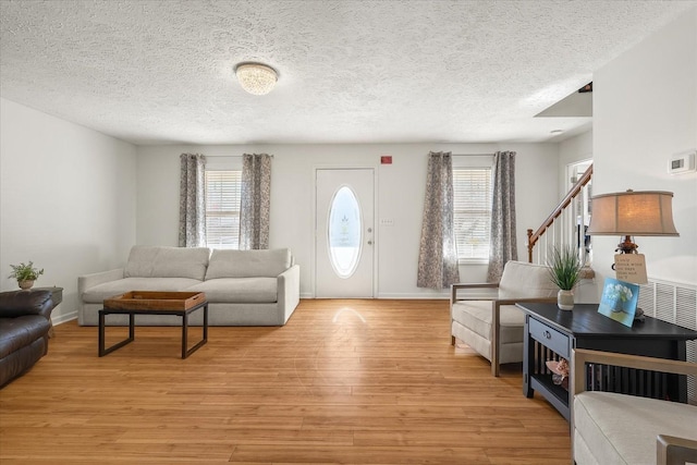 2720 Buckner Rd, Thompsons Station, TN 37179 - living area featuring light wood-style floors, a textured ceiling, and stairway