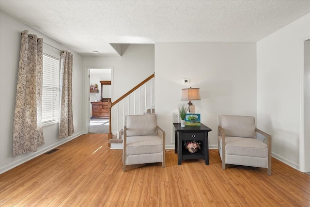 2720 Buckner Rd, Thompsons Station, TN 37179 - sitting room featuring light wood-type flooring, stairway, and a textured ceiling