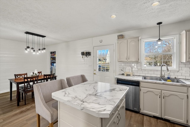 2720 Buckner Rd, Thompsons Station, TN 37179 - kitchen with a textured ceiling, stainless steel dishwasher, dark wood-style flooring, light countertops, and backsplash