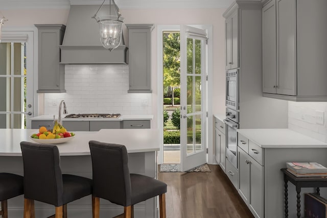 1450 Championship Blvd, Franklin, TN 37064 - kitchen with gray cabinetry, light countertops, ventilation hood, a chandelier, and ornamental molding
