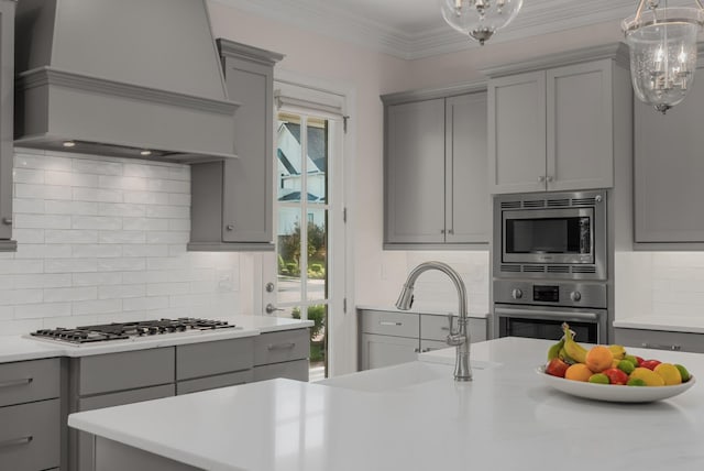 1450 Championship Blvd, Franklin, TN 37064 - kitchen featuring gray cabinets, a chandelier, custom exhaust hood, and ornamental molding
