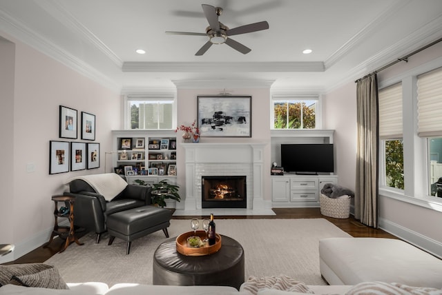 1450 Championship Blvd, Franklin, TN 37064 - living area featuring healthy amount of natural light, a ceiling fan, wood finished floors, a fireplace, and crown molding