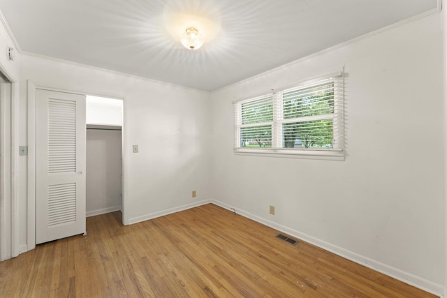 307 Mary Sharp Dr, Decherd, TN 37324 - unfurnished bedroom with light wood-style flooring, crown molding, and a closet