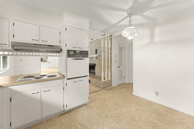 307 Mary Sharp Dr, Decherd, TN 37324 - kitchen featuring white appliances, white cabinets, under cabinet range hood, light countertops, and ornamental molding