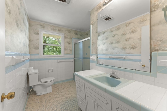 307 Mary Sharp Dr, Decherd, TN 37324 - bathroom with wallpapered walls, vanity, a shower stall, wainscoting, and tile walls