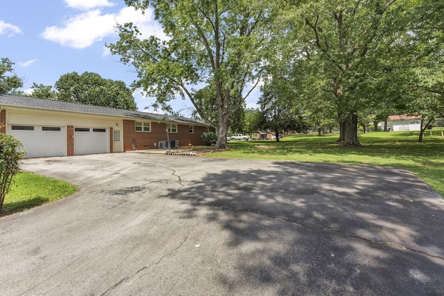 307 Mary Sharp Dr, Decherd, TN 37324 - view of front of property featuring concrete driveway, a front yard, a garage, and brick siding