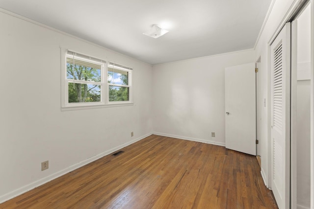 307 Mary Sharp Dr, Decherd, TN 37324 - unfurnished bedroom featuring hardwood / wood-style floors, ornamental molding, and a closet