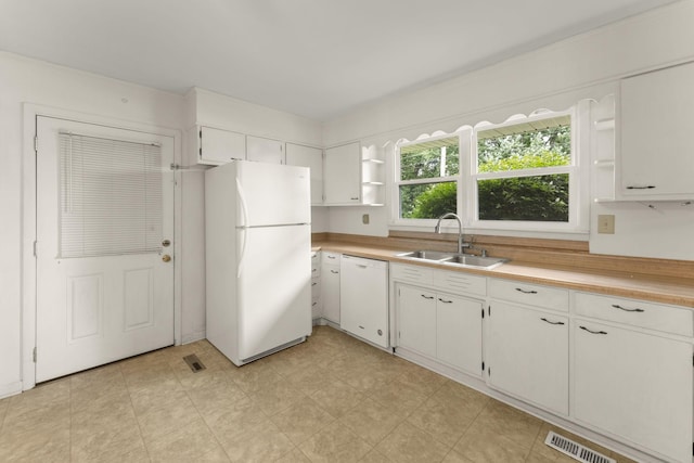 307 Mary Sharp Dr, Decherd, TN 37324 - kitchen with open shelves, white appliances, light countertops, and white cabinets