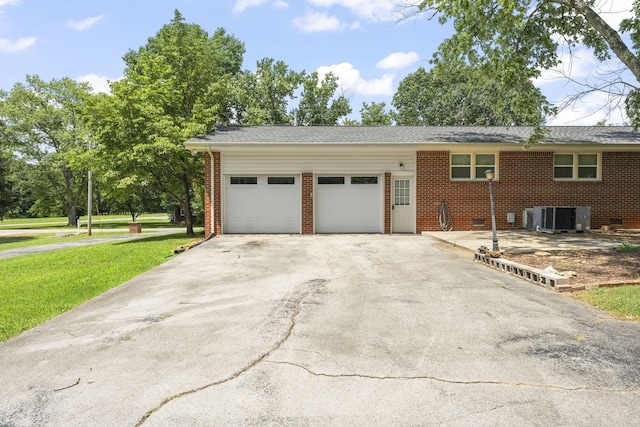 307 Mary Sharp Dr, Decherd, TN 37324 - view of property exterior featuring brick siding, an attached garage, driveway, and a lawn