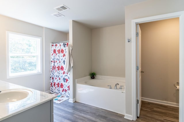 135 Millers Ln, Calhoun, GA 30701 - bathroom featuring wood finished floors, a garden tub, vanity, and a shower with shower curtain