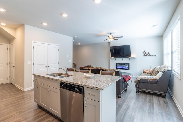 135 Millers Ln, Calhoun, GA 30701 - kitchen featuring stainless steel dishwasher, open floor plan, light wood-style flooring, light stone countertops, and recessed lighting